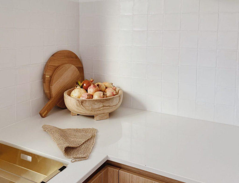 Warm and organic kitchen design featuring our white handmade square tiles