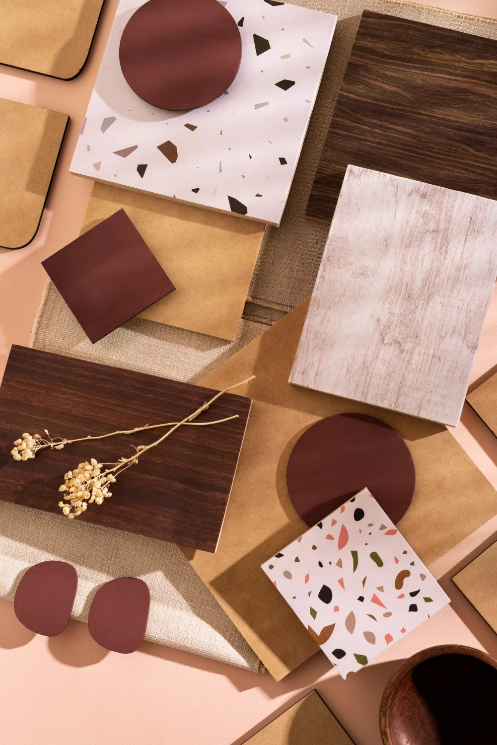 Tile, timber and terrazzo samples in a warm material palette