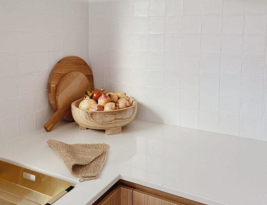 Warm and organic kitchen design featuring our white handmade square tiles